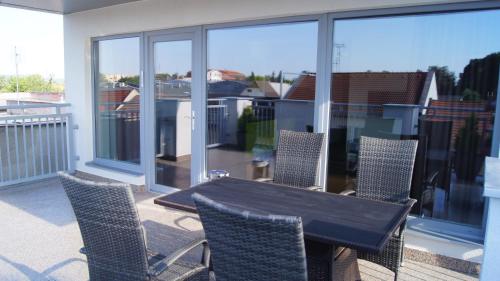 a table and chairs on a balcony with a view at Apartman Panorama in Štúrovo