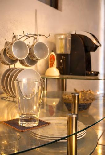 a glass cup on a glass table with a tea pot at Great location Groundfloor near Calzada in León