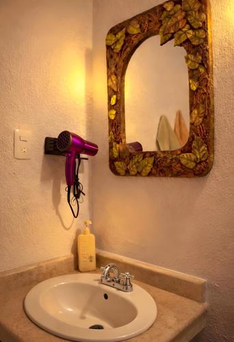 a bathroom sink with a hair dryer and a mirror at Great location Groundfloor near Calzada in León