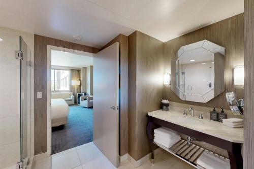 a bathroom with a sink and a mirror at Sheraton McKinney in McKinney