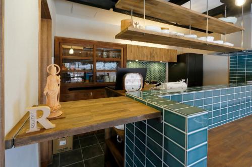 a kitchen with a blue tiled counter top at Nara Guesthouse Kamunabi in Nara