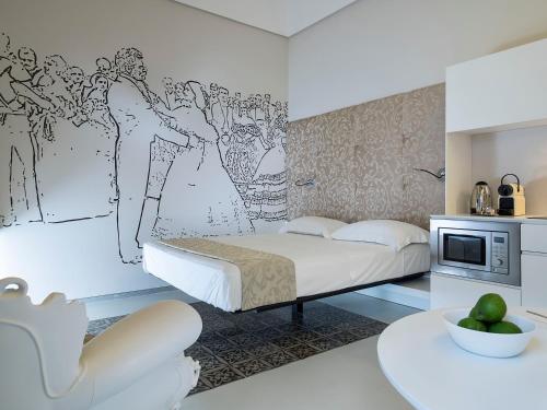 a bedroom with a bed with a drawing on the wall at Duomo Suites & Spa in Catania
