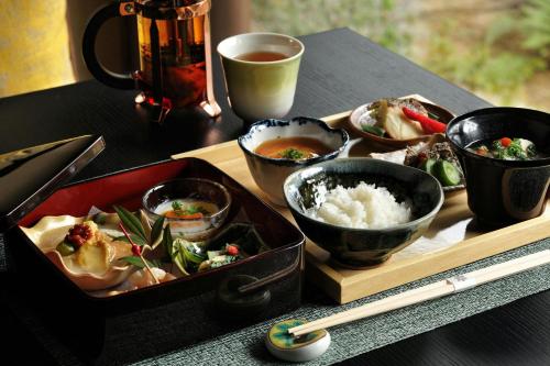 a tray of food on a table with bowls of food at Shisui, a Luxury Collection Hotel, Nara in Nara