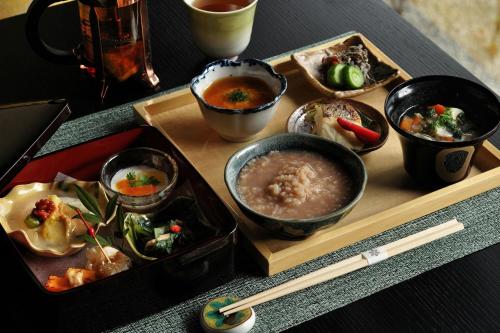 a tray of food with bowls of food on a table at Shisui, a Luxury Collection Hotel, Nara in Nara