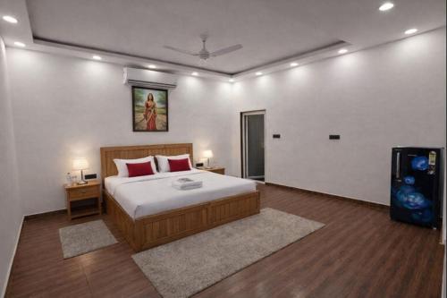 a bedroom with a bed and a television in it at Mud Meadows - Peace and Tranquility 3br Farm in Faridabad