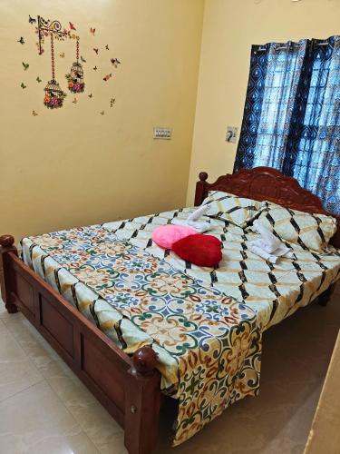 a bed with two pillows on it in a bedroom at Nilan Aarudhra Homestay in Chidambaram