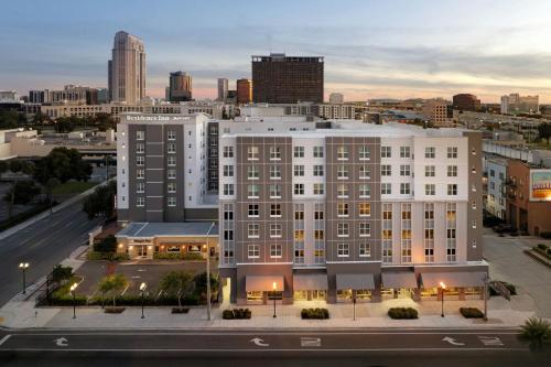 a large white building with a city in the background at Residence Inn by Marriott Orlando Downtown in Orlando