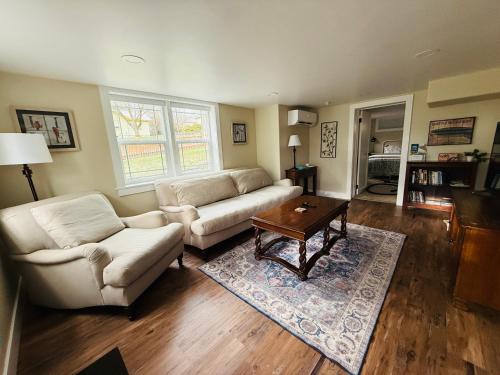 a living room with two couches and a coffee table at State Street Cottage, Suite 1 in Pullman