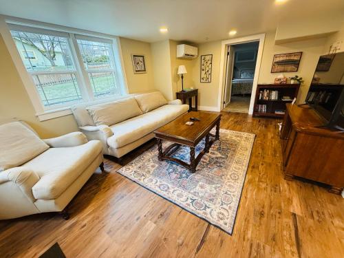 a living room with two couches and a coffee table at State Street Cottage, Suite 1 in Pullman