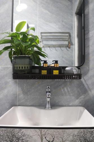 a bathroom sink with a faucet and a mirror at Sary's Homestay in Liên Trì (4)