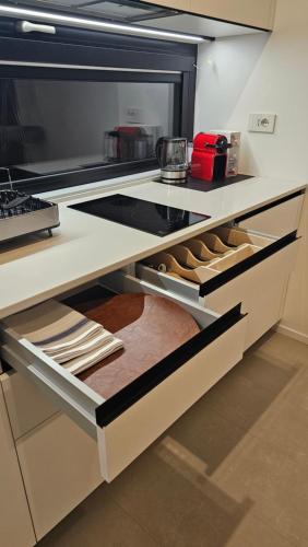 a kitchen with an open drawer with lots of shoes at Interno 8 in Padova