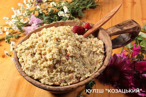 a bowl of food on a wooden table with berries in it at Dykyi Khutir in Melʼniki