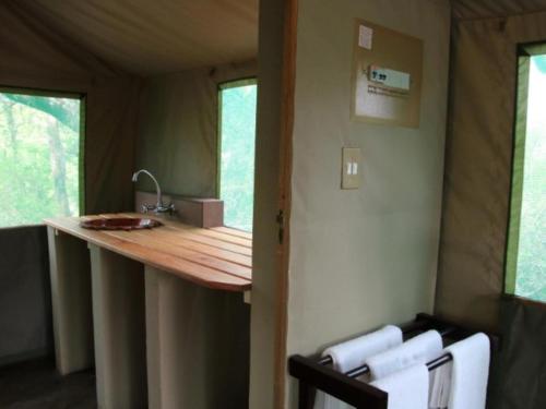 a kitchen with a counter in a tiny house at Awelani Eco Tourism Lodge in Masisi