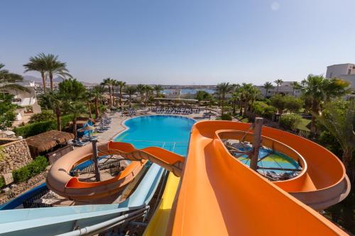 
a pool filled with lots of colorful umbrellas at Tropitel Naama Bay Hotel in Sharm El Sheikh
