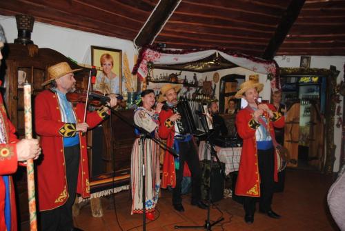 a group of people in costumes playing music at Dykyi Khutir in Melʼniki