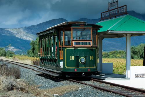 a green trolley on the tracks at a train station at Akademie Street Boutique Hotel in Franschhoek