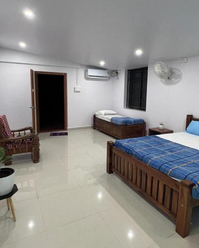 a bedroom with two beds in a room at Costa Rica in Kumta