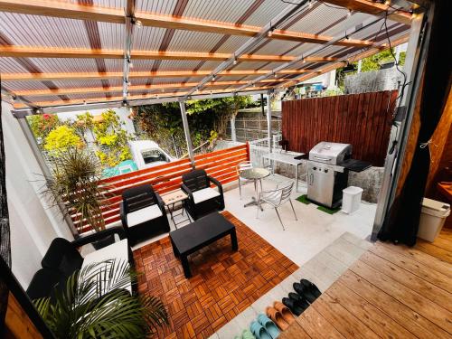 a patio with chairs and a table and a grill at Resort Villa 海結-umiyui- in Onna