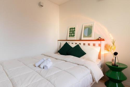 a bedroom with a white bed with a stuffed animal on it at 루미에르h호텔 in Seoul
