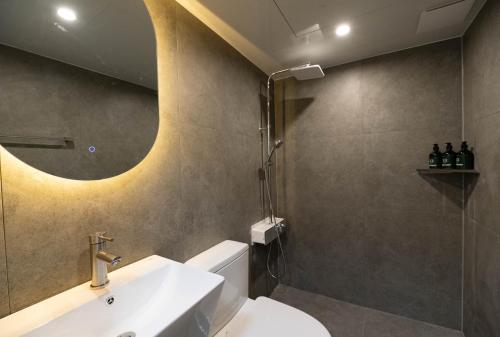 a bathroom with a sink and a shower at 루미에르h호텔 in Seoul