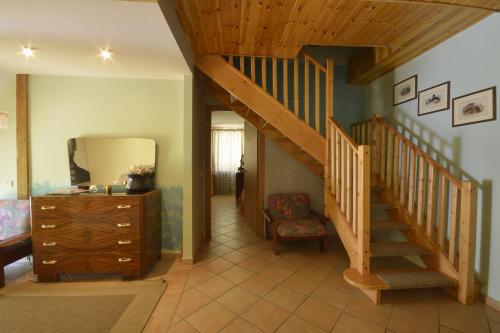 a living room with a staircase and a mirror at Hotel Pineta Ristorante country house in Fabriano in Campodonico