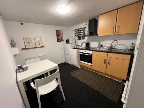 a small kitchen with a table and a counter top at Mini Hus in Märsta