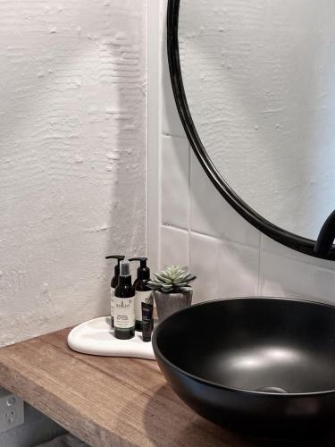 a bathroom with a black sink and a mirror at Pool Heated Lake Views 1BR Apartment in Coal Point