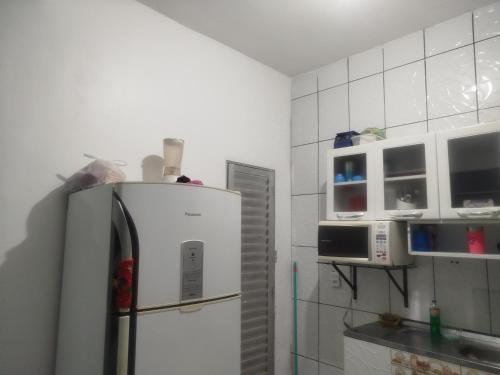 a kitchen with a refrigerator and white walls at Casa dois quartos 5 pessoas, no centro de Belém in Belém