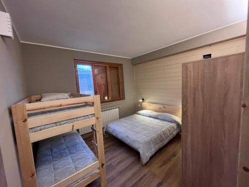 a bedroom with two bunk beds and a window at CAMPING VILLAGE Orsa Minore in Campo di Giove