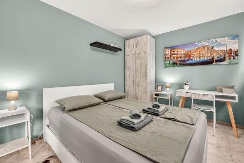 a bedroom with a bed and a desk in it at Dany's Apartments in Varna City