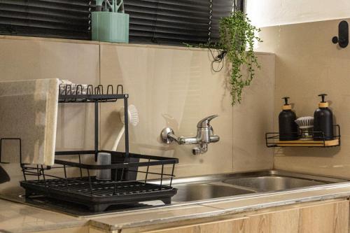 a kitchen sink with a metal rack next to it at Thorne's crip in Pretoria
