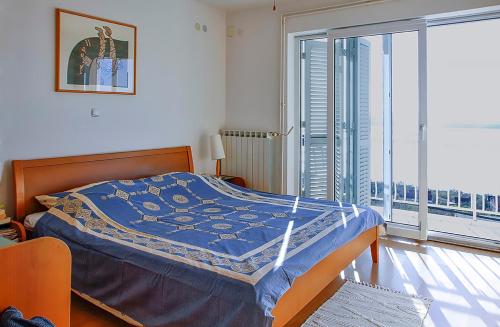 a bedroom with a bed and a large window at Holiday Home Marija with Pool & Garden & Amazing Sea View in Dramalj