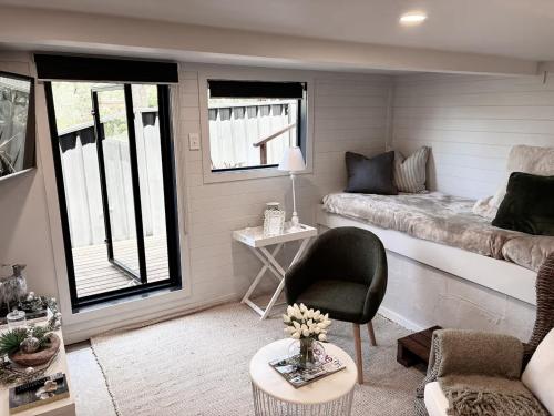 a small living room with a couch and a table at Courtyard Pool Studio Private Luxe Retreat in Coal Point