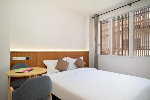 En eller flere senge i et værelse på OH Suites 72