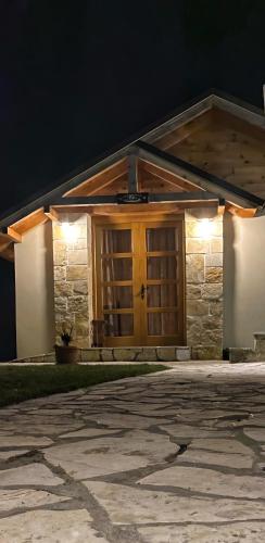 een huis met een houten deur met verlichting bij Princess Nina Kolašin in Kolašin