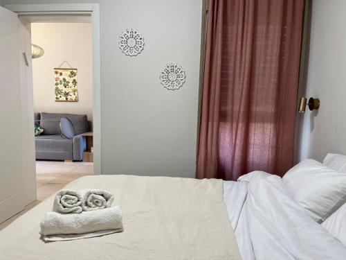 a bedroom with a bed with towels on it at מול ים המלח in Ovnat