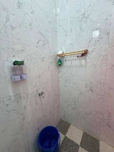 a bathroom with a shower with a marble wall at Tropical garden regency N2 in Sibolangit