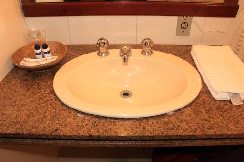 a bathroom sink with two toothbrushes on a counter at Hotel Luxor in Ouro Preto