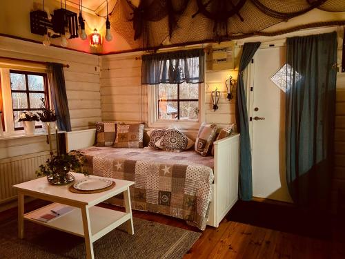 a small bedroom with a bed and a table at Kaj's Cabin in Listerby