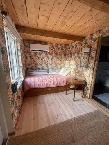 a room with a bed and a table in it at Stuga i Maglehem in Degeberga