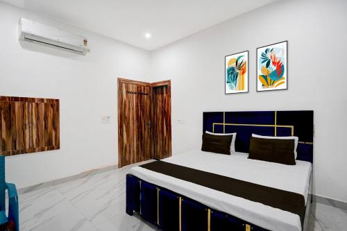 a bedroom with a large bed in a room at Hotel O by OYO Radha Raman Guest House in Rait