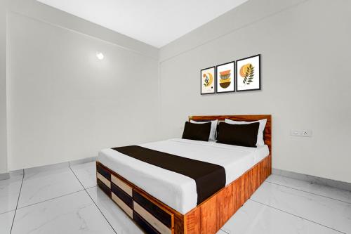 une chambre avec un lit dans une pièce blanche dans l'établissement Hotel O THAIBA RESIDENCY, à Kuttyādi