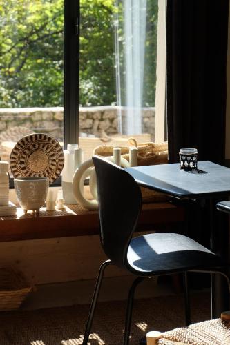 ein Tisch und zwei Stühle vor einem Fenster in der Unterkunft Maison Fontbelle By OTTO in Angoulême