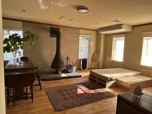 a living room with a couch and a fireplace at hayama satoyado in Hayama