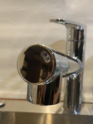 a close up of a faucet on a sink at hayama satoyado in Hayama
