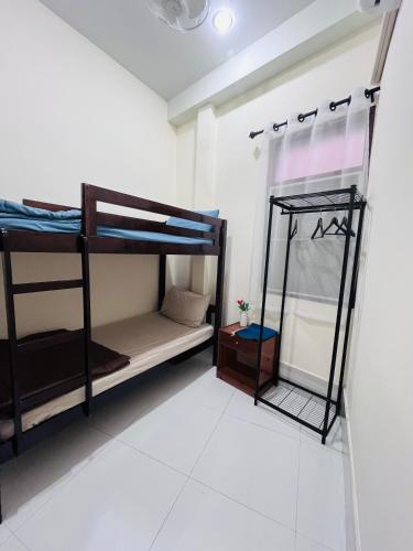a room with bunk beds and a mirror at Farwa home in Kampong Rusamileh