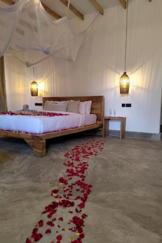 a bedroom with a bed with roses on the floor at Our Stay Mlima in Arusha