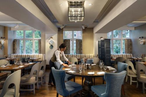 a woman sitting at a table in a restaurant at St. Ermin's Hotel, Autograph Collection in London
