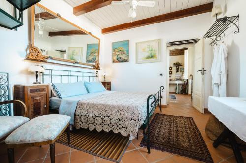 a bedroom with a bed and a table in a room at Tenuta Rasocolmo in Messina