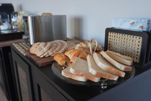 a plate of bread and sandwiches on a table at Aux étangs fleuris in Rochefort